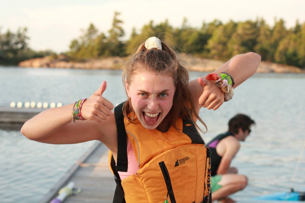 Mikaela giving two big thumbs up. She's wearing a MEC Fulcrum, one of the best budget life jackets.
