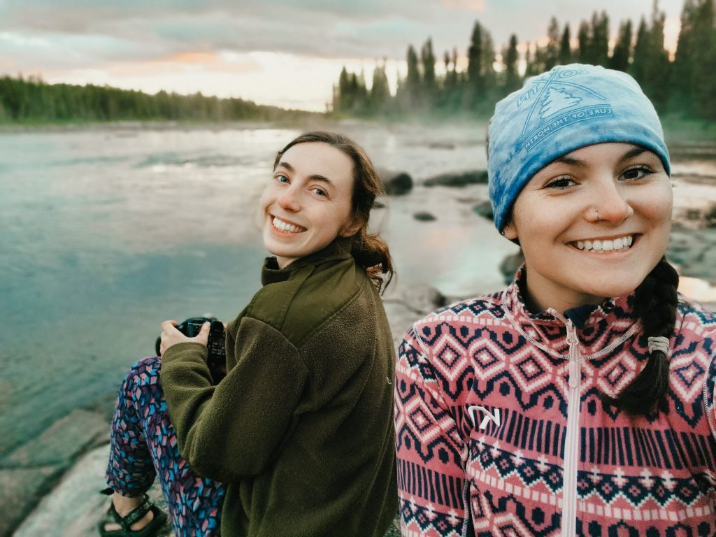 What to wear canoeing at the campsite: two women in fleece sweaters on the Missinaibi River.
