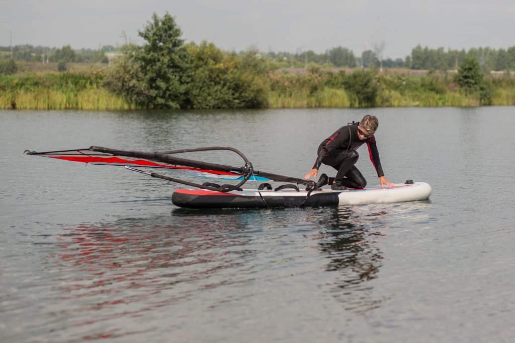 Woman with a wetsuit on a SUP